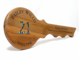 Bailey Willis' Rimu 21st key with a pāua inlaid 21.