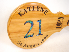 Katlyne's rimu 21st key, the 21 has been inlaid with pāua the rest of the text, and books, are laser engraved.