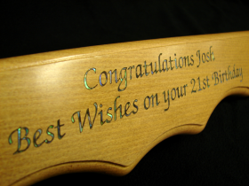 Rimu 21st key, laser engraved, and inlaid with pāua.