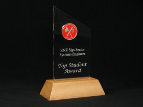 A die cast coin mounted in acustom Atlanta presented as theTop Student Award - RNZ Sigs Senior Systems Engineer for the School of Signals