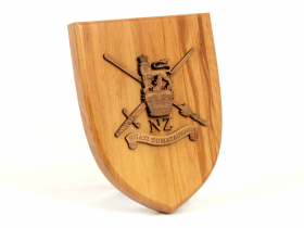 A 180mm Shield with the NZ Army badge made from rimu mounted on top.