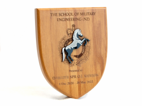 A 180mm Shield with the NZ Army's School of Military Engineering badge made from black acrylic mounted on top.